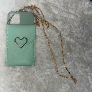 A jade green cover with a pocket that you can put credit card with a gold chain